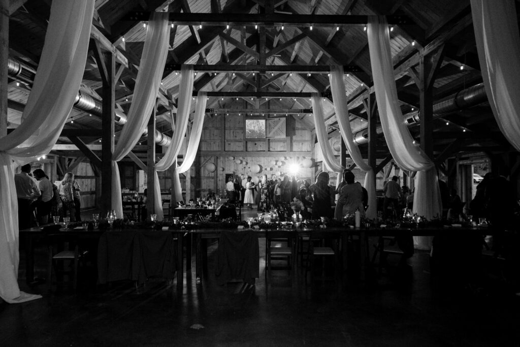 a wedding photographer captured a dramatic black and white shot of a reception venue during the part