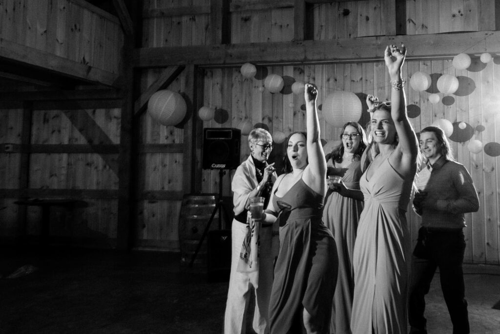 a group of wedding guests dance on the dance floor