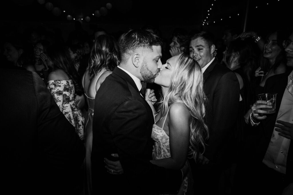 wedding photographer captures newlyweds kissing on the dance floor