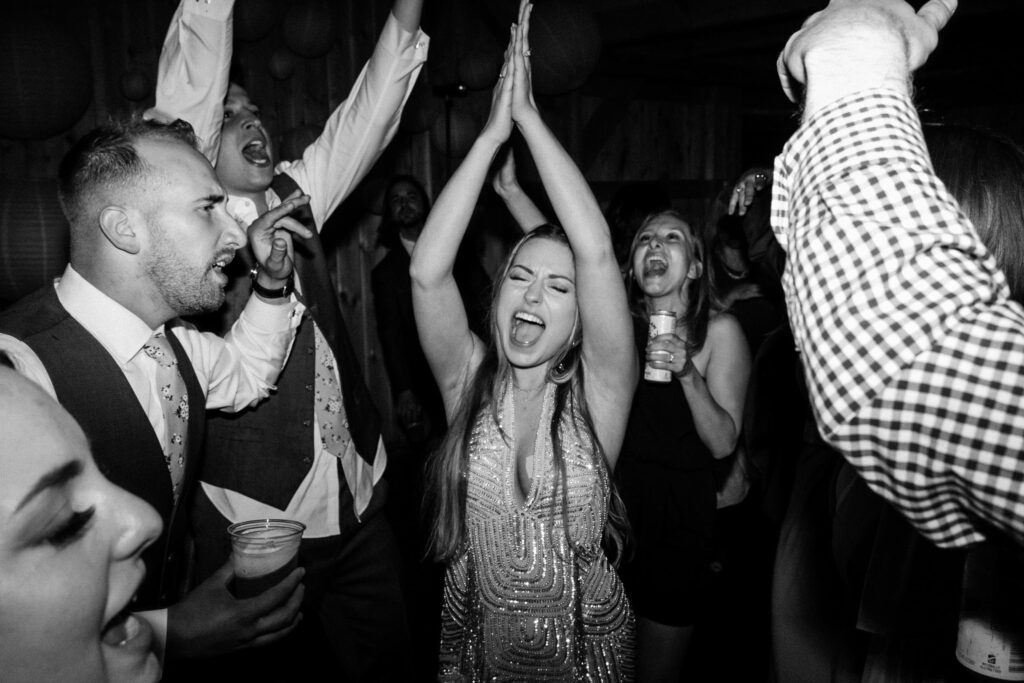 wedding photographer captured the bride dancing excitedly with guests